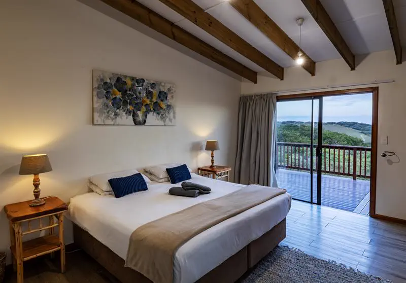Cottage bedroom with a king-size bed and sliding doors to the deck