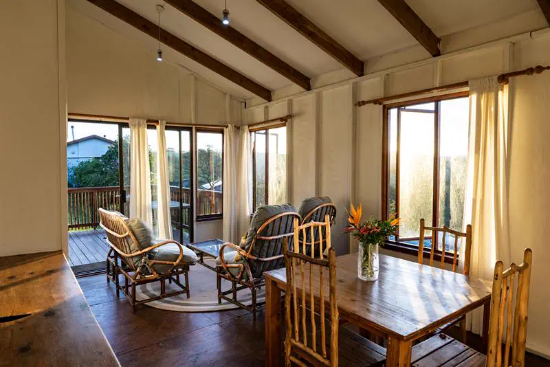 Cottage lounge and dining area with views through large windows