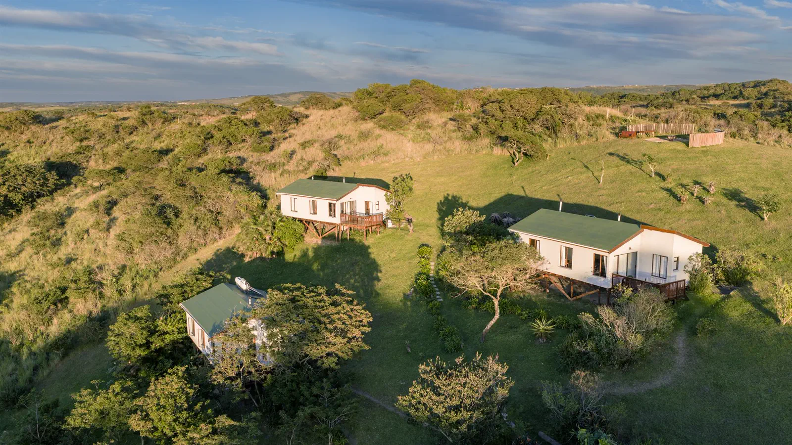 Cottages on the grassy hilltop in soft evening light